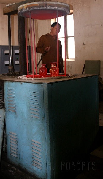 cloisonne3.jpg - Once it's all loaded up they put it in a kiln and fire it up!  Those vases are metal... cherry red, hot metal.