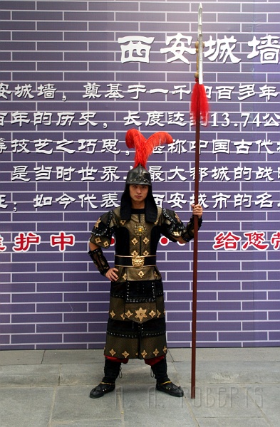 x1.jpg - The city of Xian stil has its walls intact which were built hundreds of years ago.  This fearsome guard protects the gate from... I'm not sure what, but he does it with style.