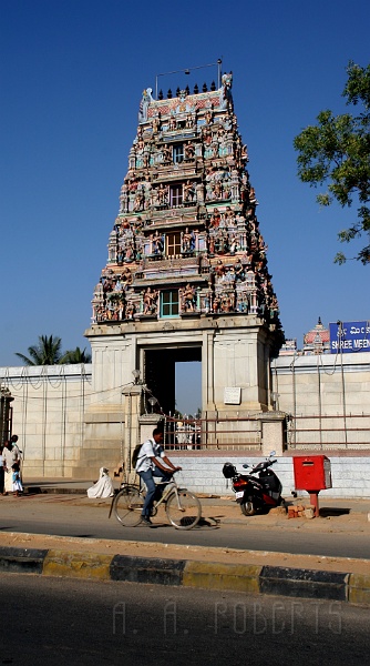 IMG_5438.JPG - Here is the outside of one of the many temples that dot the landscape of Bangalore.  What's strange about this picture?  The bicyclist isn't in the middle of the road?  What's he doing driving on the sidewalk?  Who weird is that?